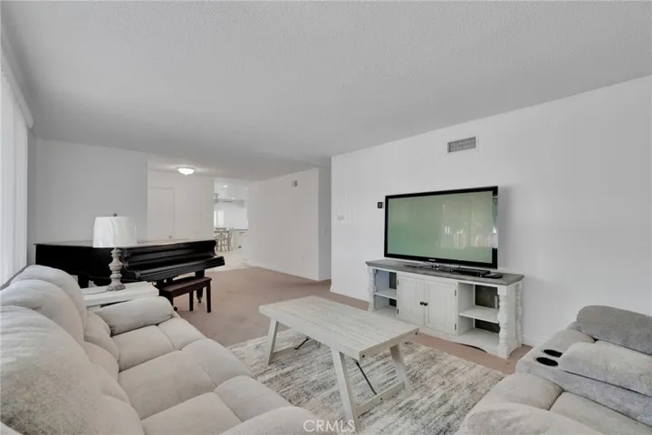 Open floor plan leading to kitchen to the left and bedrooms to the right