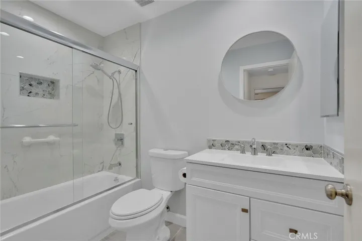 Remodeled Hallway bathroom with tub in shower