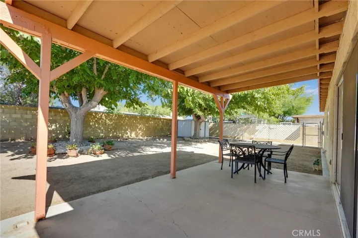 Backyard with covered patio, dog run & storage shed