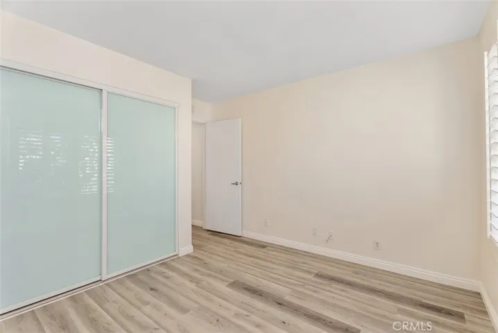 Guest bedroom with custom closets.