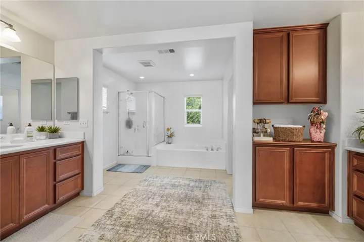 Spacious Primary Bathroom showing hishers vanity areas and full tub and shower.