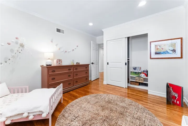 Whimsical child's bedroom with adjustable custom closets for growing needs, plantation shutters and newer windows. What a room to play, grow up and dream in!