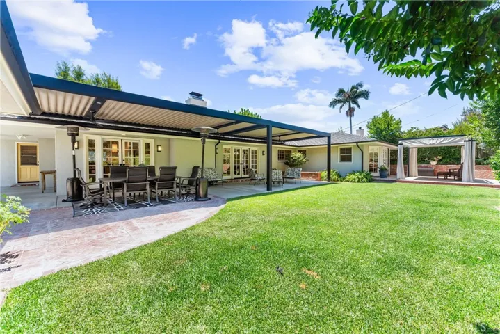 Lawn and yard equipped with an automatic sprinkler system, ensuring the landscape remains pristine. 
This home offers a luxurious lifestyle with every detail carefully curated for comfort, style and functionality.