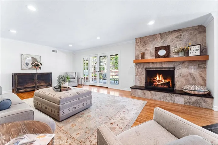 Marble gas fireplace with custom wood mantle. Every feature has been thoughtfully considered. (ie. tailored cutout in wood mantle to unobtrusively plug into outlet)