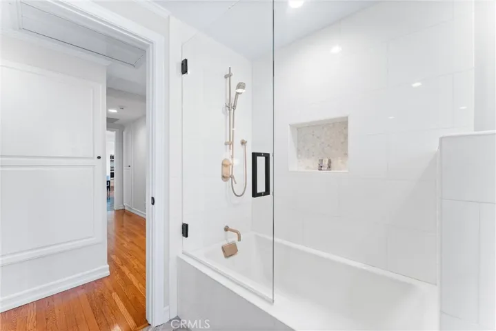 Marble shower with accent tile inset, with premium gold hardware and full tub
