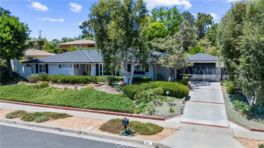 Nestled in Raymond Hills. This low maintenance yet green front yard with mature landscaping enhances the home's curb appeal.