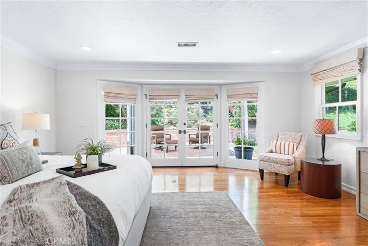 Enormous primary suite retreat with direct access to private patio gazebo. Neutral warm palette provides a peaceful setting to enjoy morning coffee under the covered patio overlooking yard