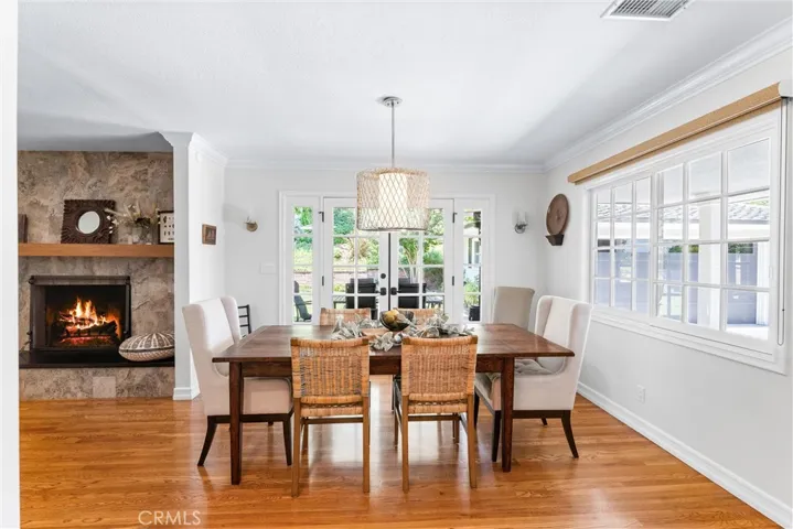 Dine by fireplace and enjoy views of the blooming trees and yard.