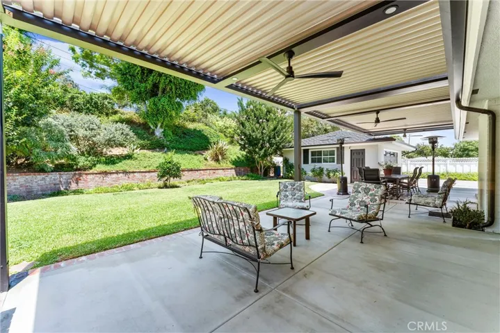 Inviting outdoor space. Built in ceiling fan, lighting with motorized remote controlled Pergola cover which can be opened for sun or closed for shade. 
Patio cover made by:StruXure