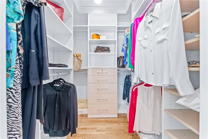 Walk-In Closet resembles a bespoke personal boutique: Fashion meets function for your entire wardrobe, space for everything, pull out drawers, belt hooks, lockable jewelry drawer, shoe shelves, valet hooks for your outfit of the day.