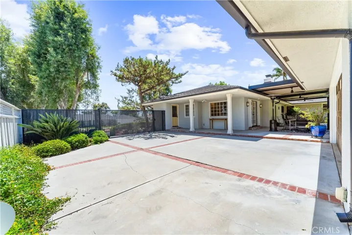Ample parking or play area with wrap around porch - ideal for kids to ride their tricycles safely.  Secured behind remote controlled driveway gate of 811 Harmony Lane - This California Ranch home is a gem.