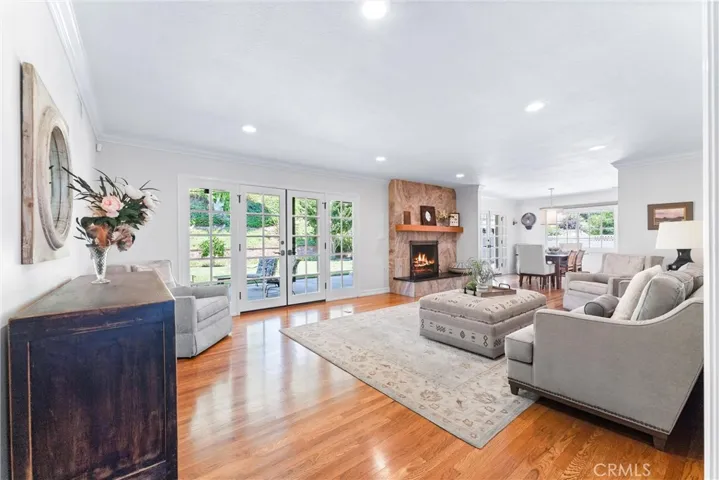 Open floorplan seamlessly connects living spaces. All French doors showcase lush backyard oasis.