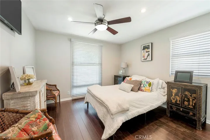Bedroom 3 with smooth ceiling, ceiling fan and engineered flooring.