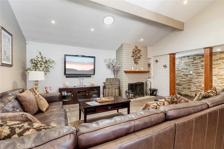 Living room with a wood burning fireplace.