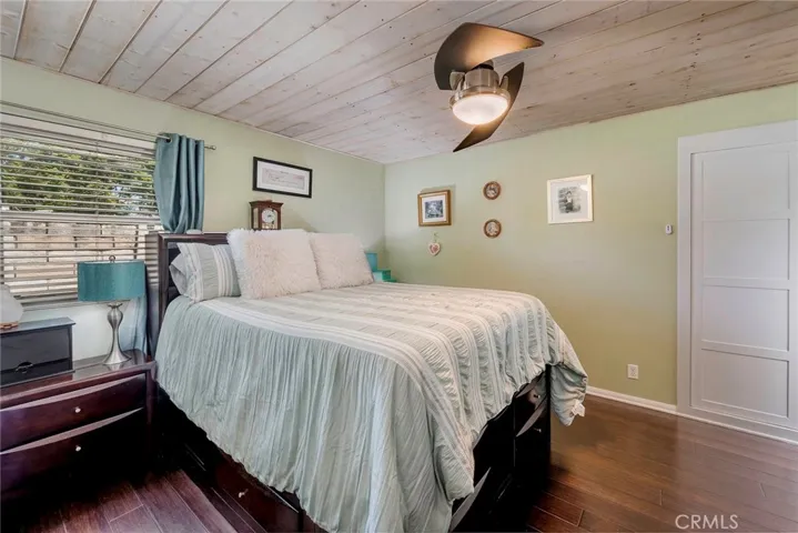 Primary bedroom with tongue and groove ceiling and designer ceiling fan.
