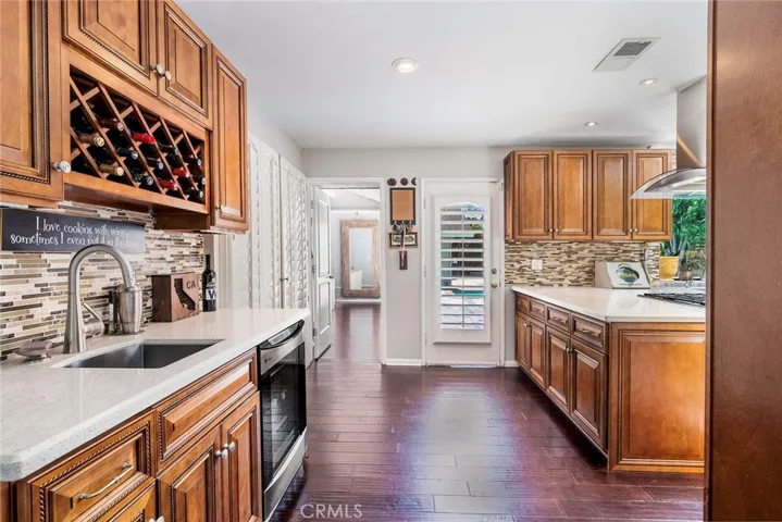 Wet bar with wine rack and beverage refrigerator.
