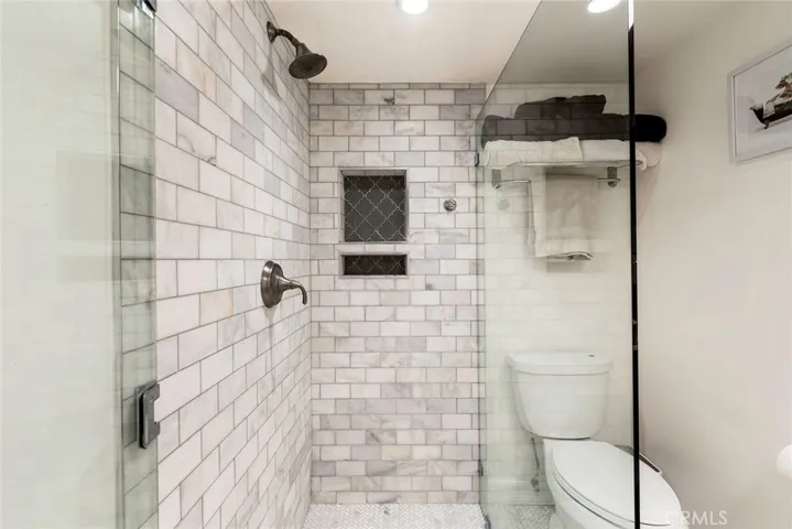Primary bath with beautiful walk-in shower and seamless glass enclosure.