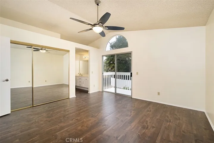 Primary Bedroom with slider door that leads out to the outdoor balcony.