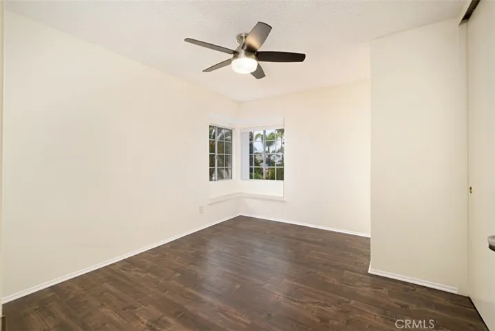 Bedroom 2 with Ceiling fan and window sitting.