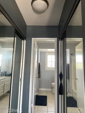 Double mirrored closets between primary bedroom and primary bathroom offering privacy in bathroom