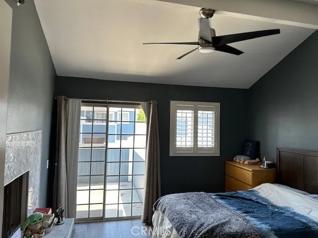Primary Bedroom with Fireplace, high ceilings and ceiling fan with private patio
