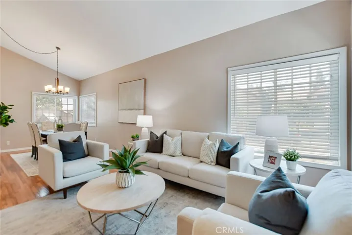 Open floor plan of Living room and dining area combined with vaulted ceiling for airy feeling once you walk in.