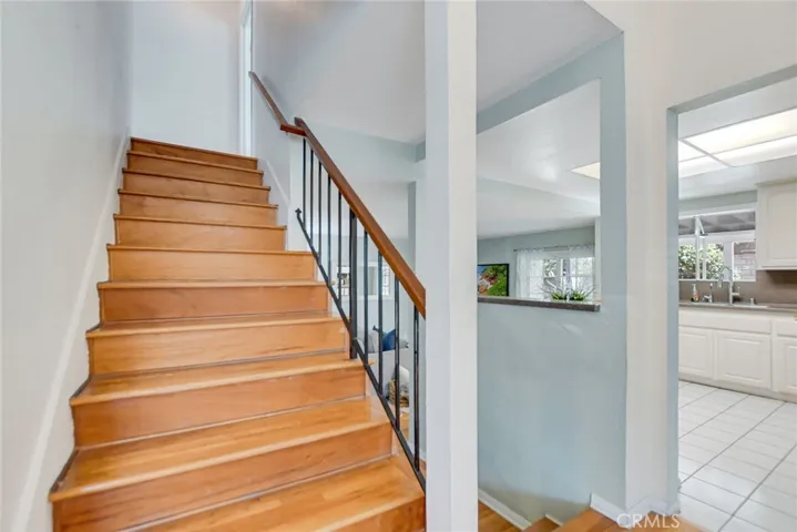 Wood flooring stairs to access the second floor.