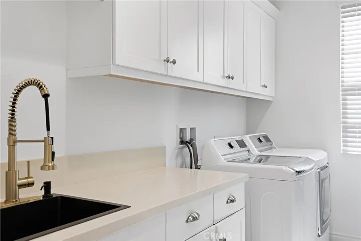 Upstairs laundry room with washer and dryer included, as well as ample storage