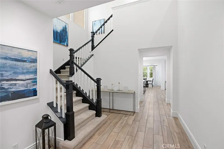 Grand entry with tall ceilings, beautiful flooring and contemporary decor