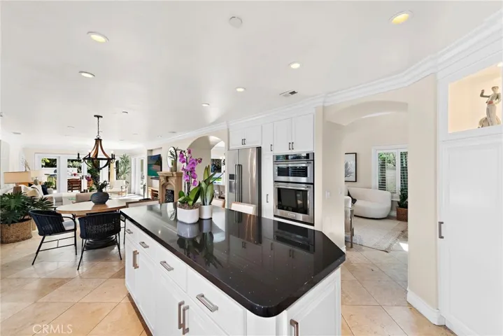 Kitchen seamlessly blends culinary space with both the family room and living room.