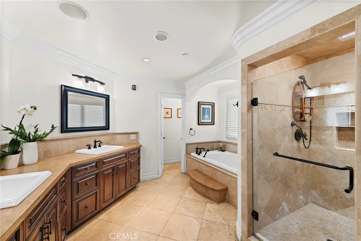 Primary bathroom features dual sinks, soaking tub, and an oversized shower.