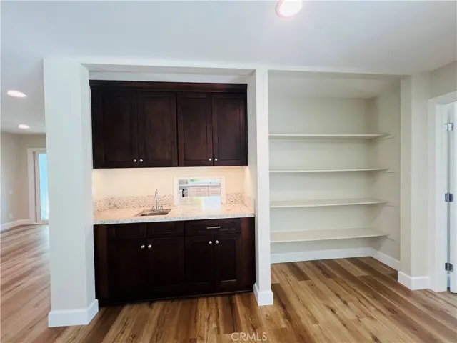 Wet bar with passage to kitchen/ storage or decorative shelving