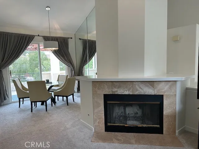 Livingroom and dining room shown with furniture before furniture removed. Gas logs have been added.