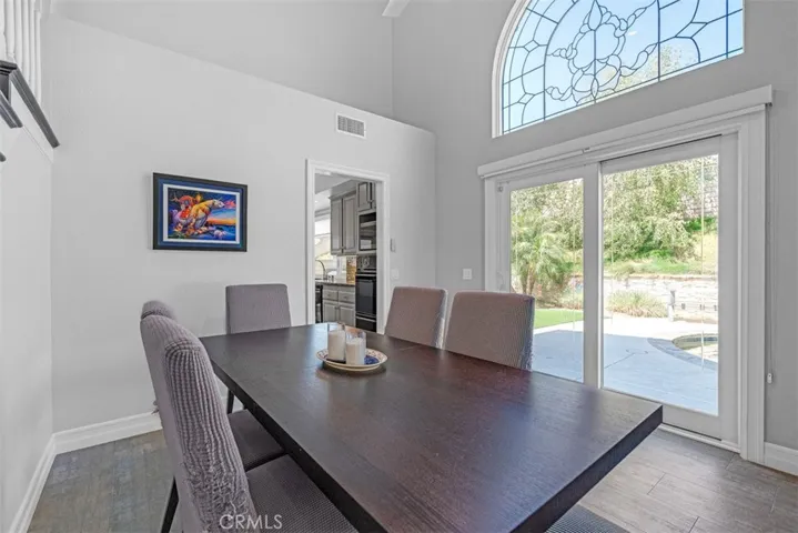 Dining room with dual pane slider door & leaded glass arched window (also has low-E glass.)