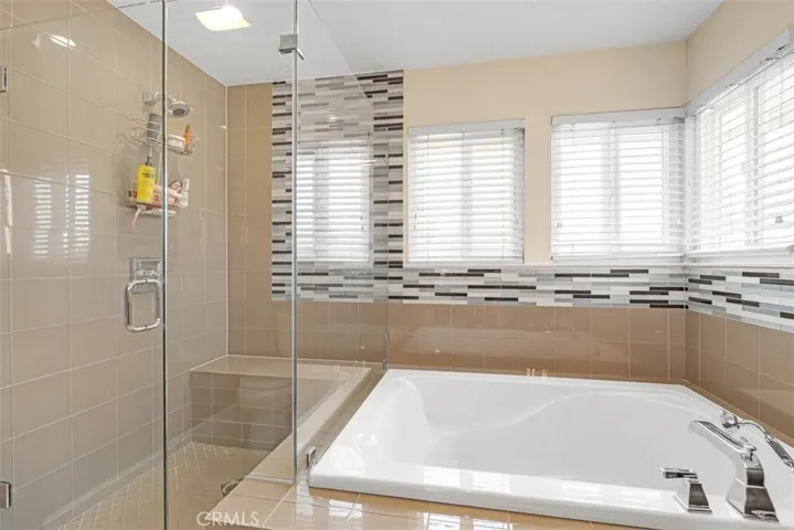 Separate shower & soaking tub. Beautiful glass tiles.