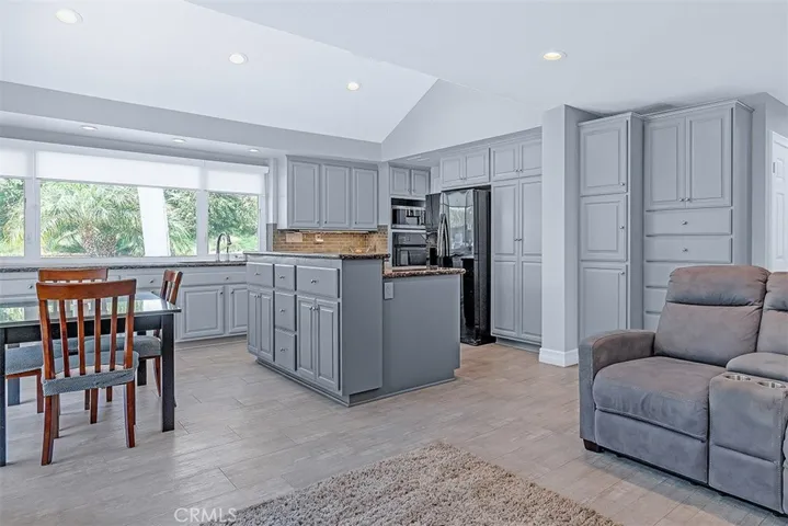 Eating Area & Kitchen w/ample cabinets & granite counter tops.