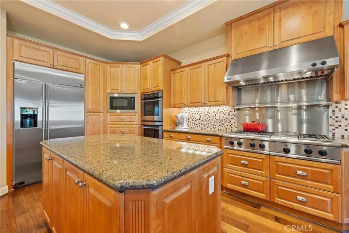 large center island, built in microwave, double Monogram oven.