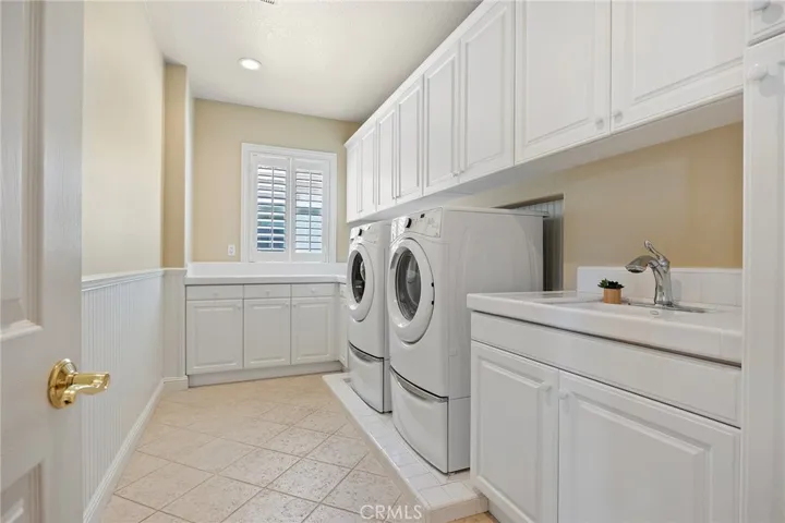 spacious laundry area includes washer and dryer.