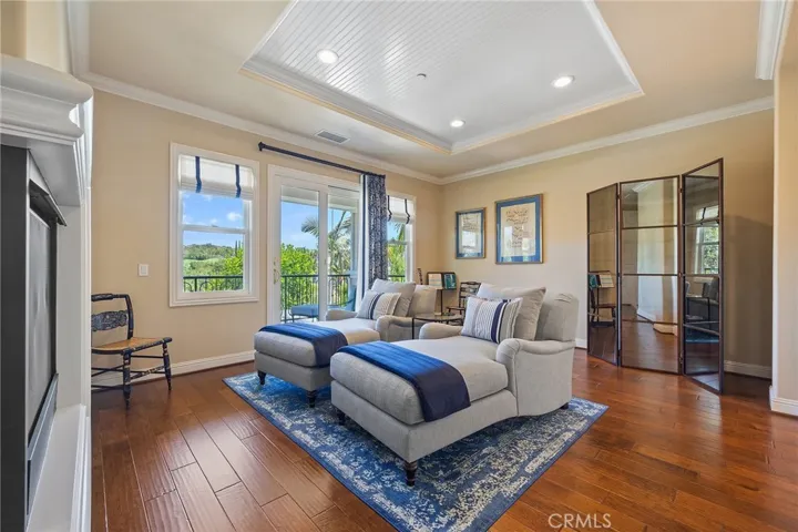 master living area overlooking the private balcony with golf course views.