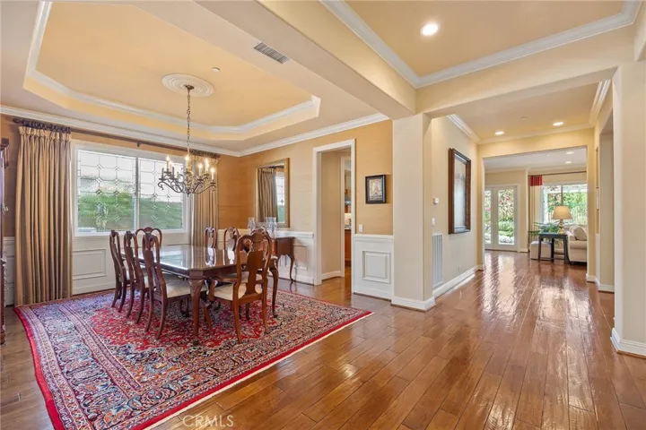 Formal dining room with wood accents, and chandelier