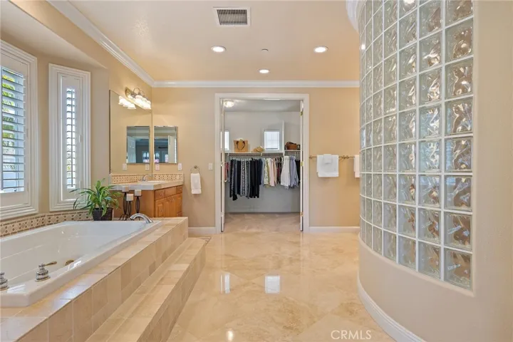 master bathroom with oversized shower, dual vanities, walk in closet and jetted tub.