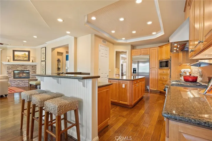 Kitchen is open to the family room and kitchen dining area. Large center island, stone counters, walk in pantry, under cabinet lighting and recessed lights.