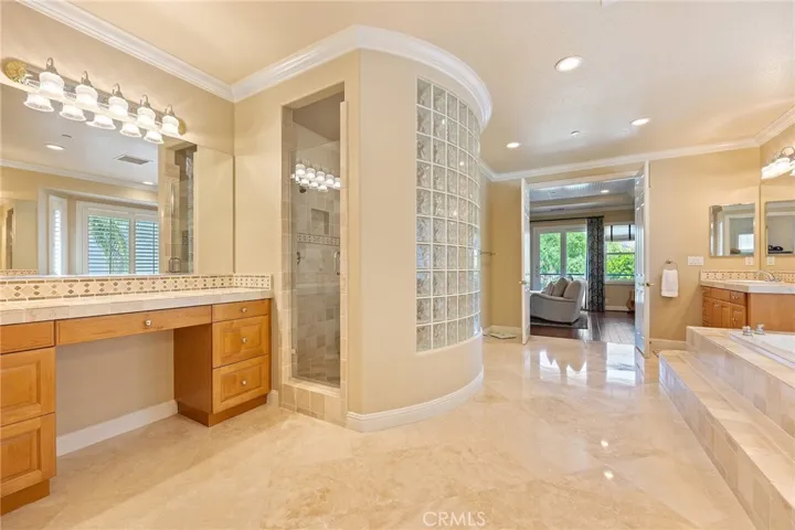 Separate makeup vanity, spacious layout. Notice the gorgeous polished travertine floors.