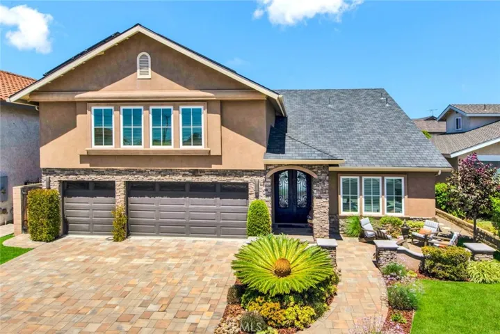 Gorgeous Exterior: Stacked stone siding, manicured landscaping, front patio w/fountain, paver driveway