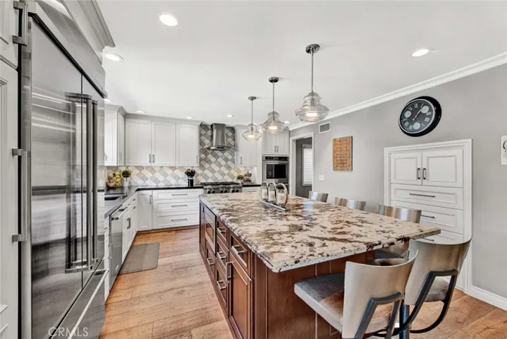 Completely Remodeled Chef's Kitchen with Leathered Granite Countertops, Professional Grade Stainless Appliances, AND... the Central Vac throughout this home has Crumb-Catcher Vents Under the Cabinetry for Easy Sweeping, no Bending Down! Yay!