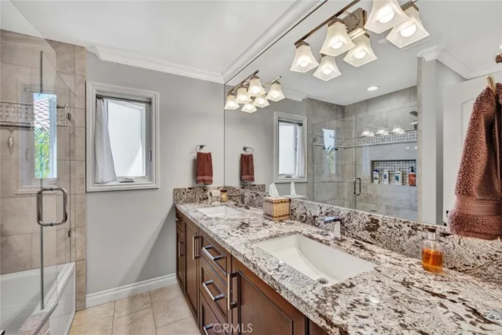 Upstairs Guest Bathroom, Beautifully Remodeled with Dual Sinks, Granite Countertops, Instant Exhaust Fan, and Tub/Shower Combo with Designer Tile Surround, Shampoo Niche, and Clear Glass Enclosure