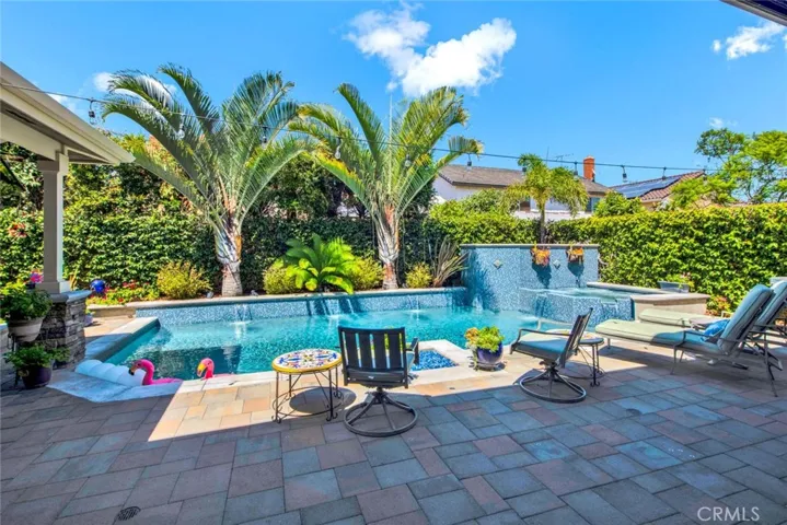 Tranquil Paradise Backyard with Saltwater Pool, Spa, Waterfalls, Glass Rock Fire Pit, Tropical Landscaping, Interlocking Paver Decking