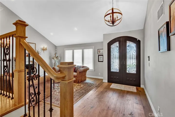 Gorgeous Foyer. Double Entry Doors with Opening Glass for Great Air Flow. Luxury Engineered Wood Flooring. Alder Wood and Wrought Iron Staircase