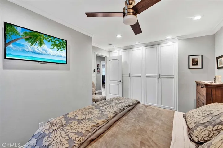 3rd Bedroom also has Closets Behind Custom-Built Cabinetry, Plus Crown Molding, Recessed Lighting, and a Ceiling Fan