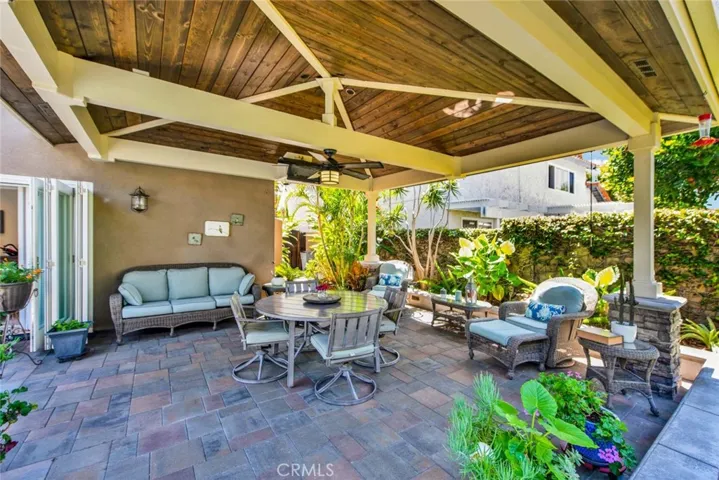 The Backyard is Adorned with this Amazing California Room with Cathedral Ceiling, Heater, TV, Speakers, Lighting, Ceiling Fan, and Sun Shades